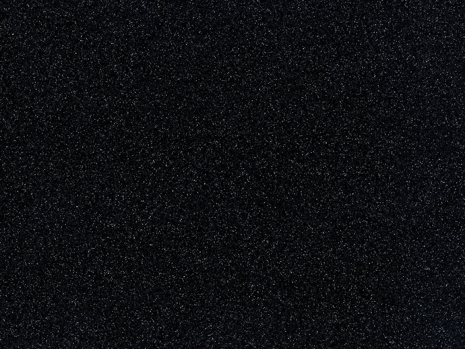 Black, textured background with tiny sparkling particles.