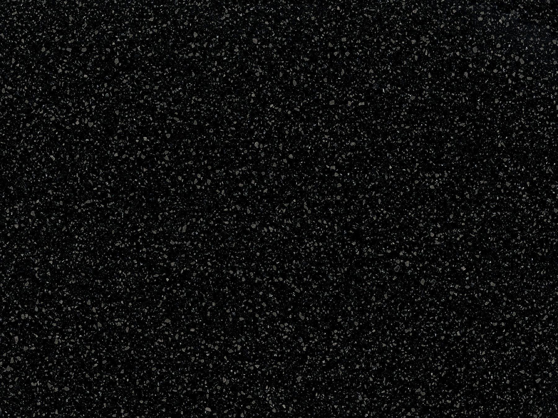 Black background with countless small, white specks, resembling stars.