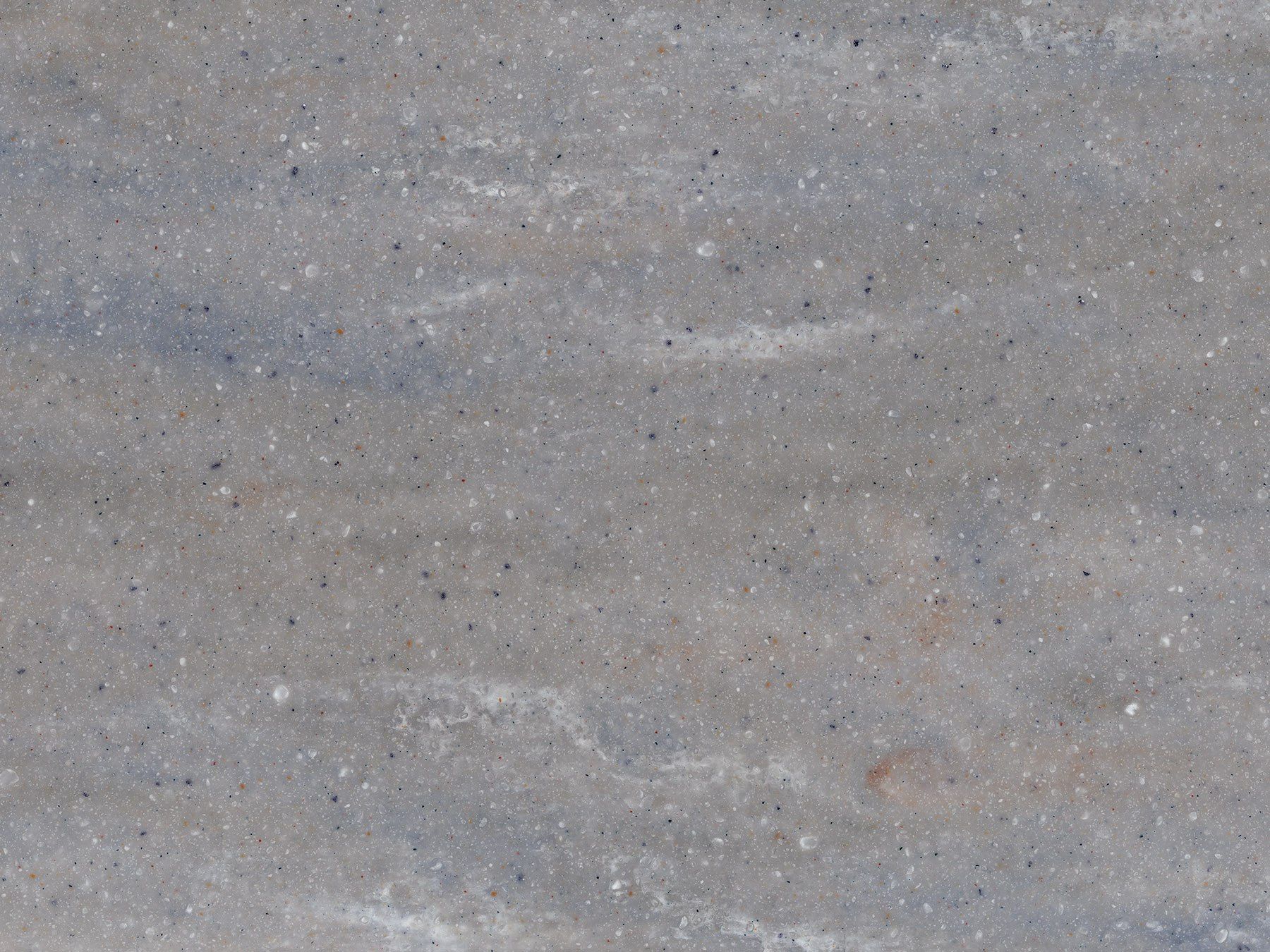 Textured gray surface with subtle horizontal streaks and tiny dark speckles.