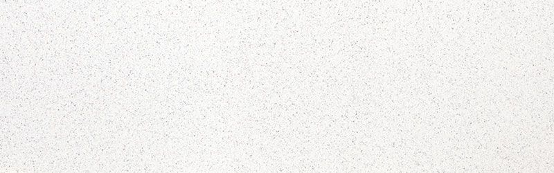 White, textured surface with small, dark specks.