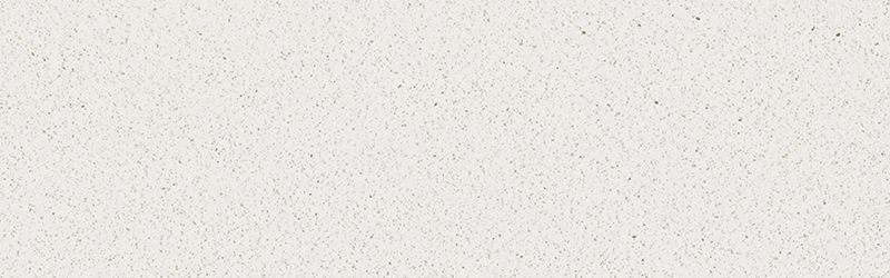 Close-up of a white, textured surface, possibly plaster or concrete. Scattered specks of color.