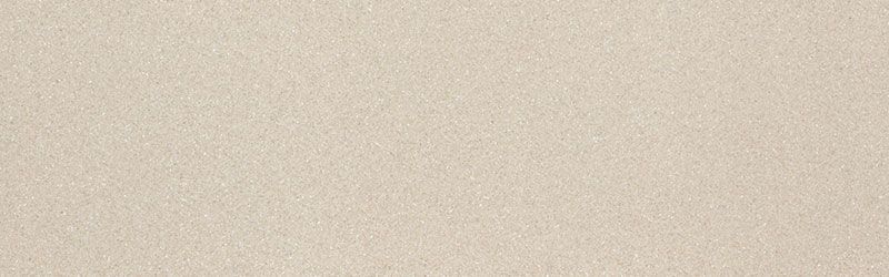 Off-white, textured surface; appears to be a wall or similar structure.