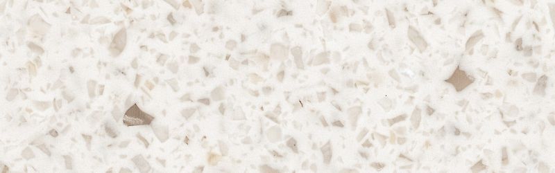 Off-white quartz countertop with speckled patterns of beige and brown.