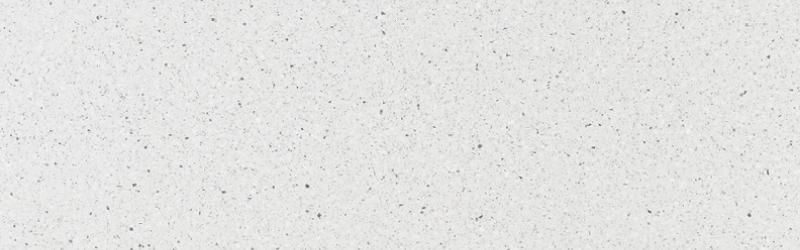 Close-up of a white, textured surface with tiny dark speckles, possibly granite or paper.