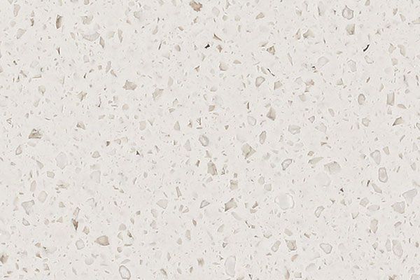 Off-white quartz countertop with small flecks of light and darker colors.