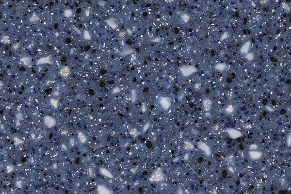 Blue speckled surface with white and black flecks.