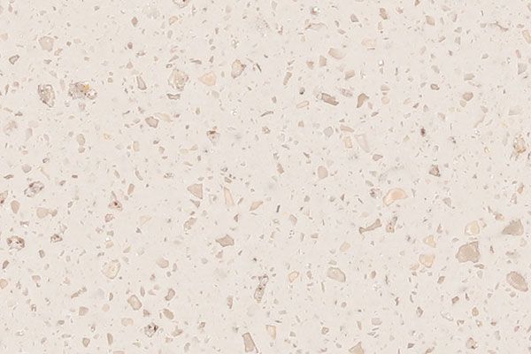 Cream-colored quartz countertop with small, speckled inclusions of beige and tan.