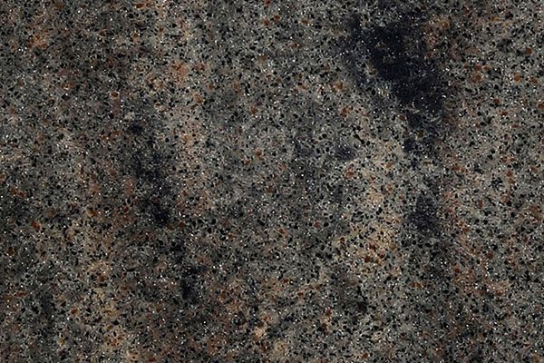 Close-up of a granite surface, mostly gray with specks of brown and black.