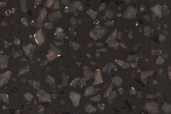 Dark brown terrazzo surface with embedded light-colored stone fragments.