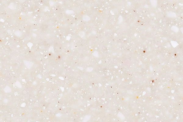 Cream-colored surface with scattered white and brown flecks, resembling a countertop or solid surface material.