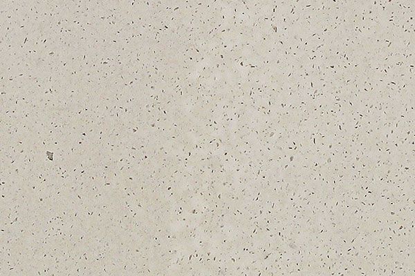 Off-white stone surface with small, dark speckled texture.