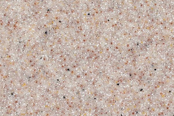 Close-up of a speckled, light-colored surface with brown and black flecks.