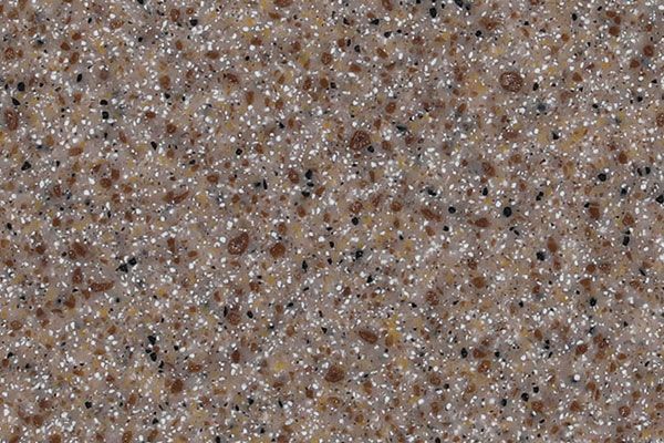Close-up of a speckled, brown and tan countertop surface with flecks of black and brown.