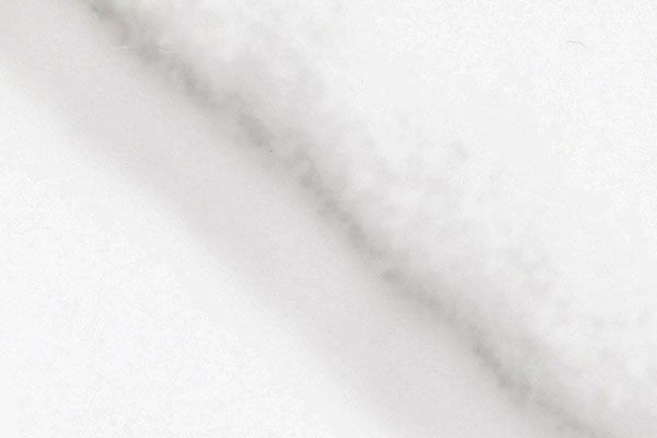 White marble surface with diagonal grey veining.
