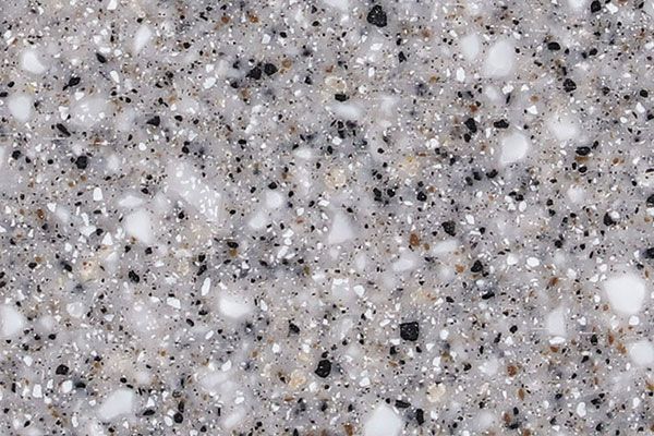 Gray speckled countertop surface with black and white flecks.