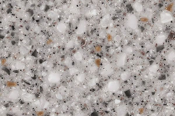 Gray and white speckled surface, resembling a countertop or similar solid surface.