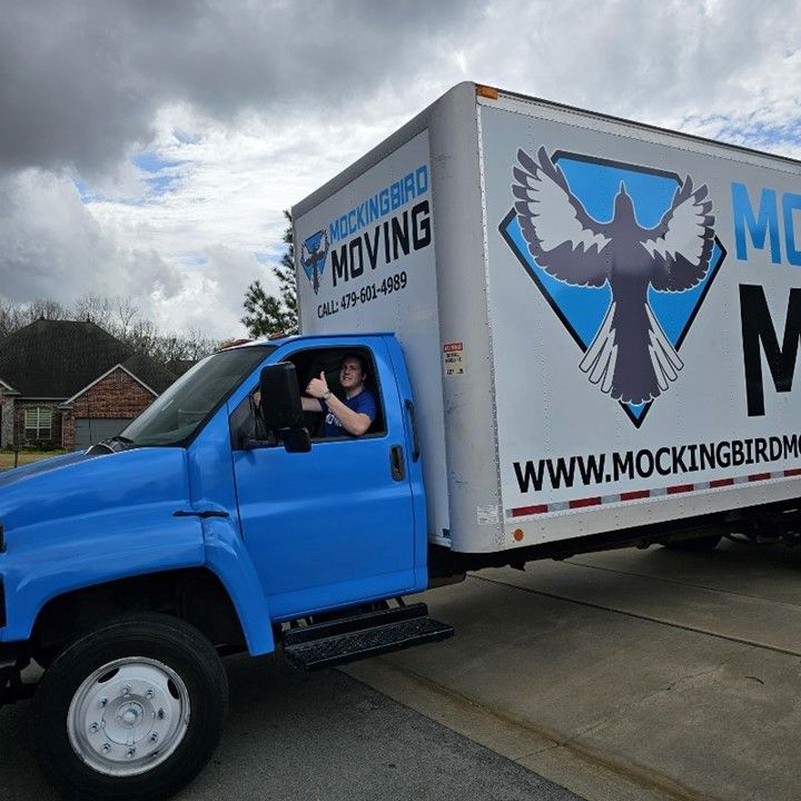 A Mockingbird Moving Truck Is Parked On The Side Of The Road - Fayetteville, AR - Mockingbird Moving