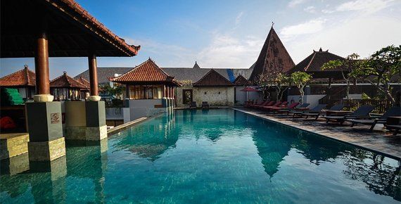 A large swimming pool with a lot of chairs around it