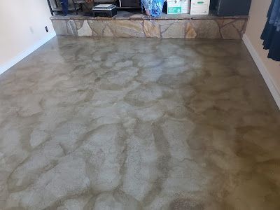 Metallic-look floor with swirling, marbled patterns in shades of gray and gold.