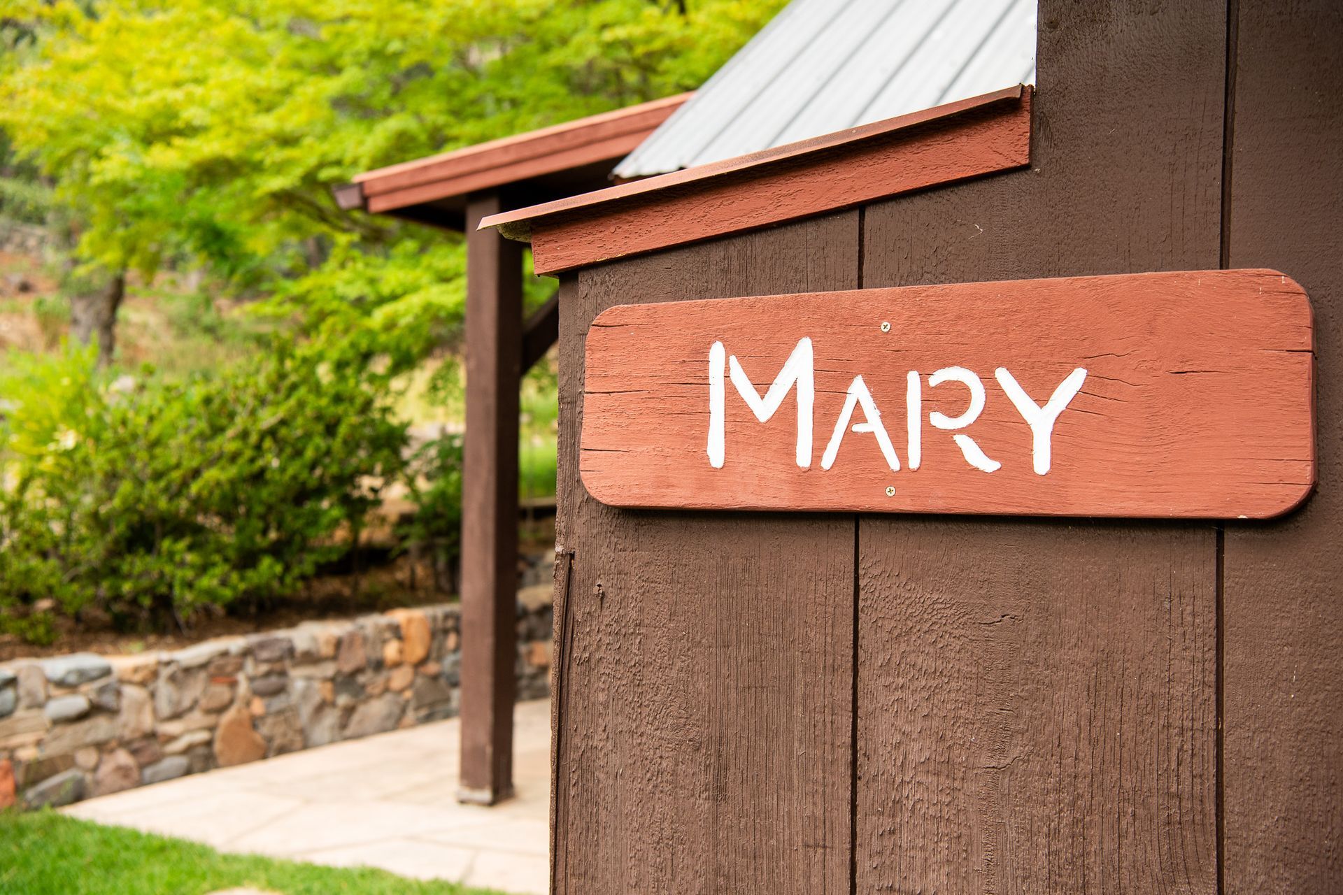 Brown wooden building with a sign that reads 