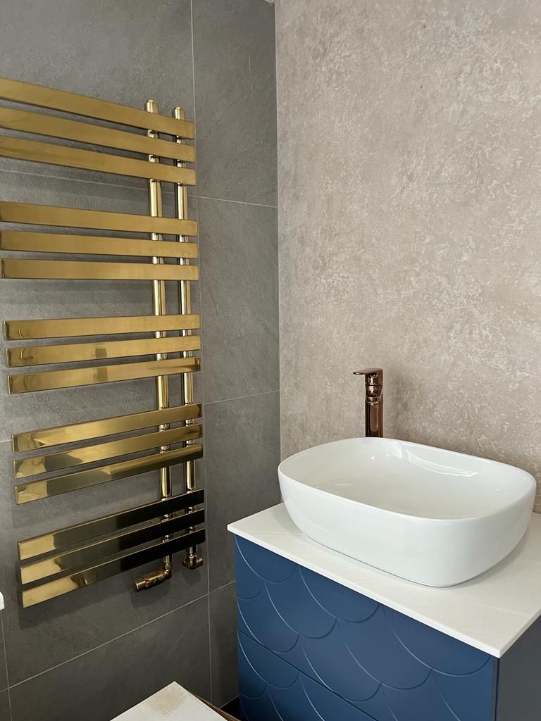A bathroom with a sink and a towel rack.