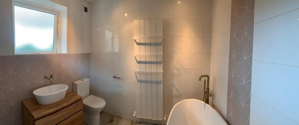 A bathroom with a sink , toilet , and shower.