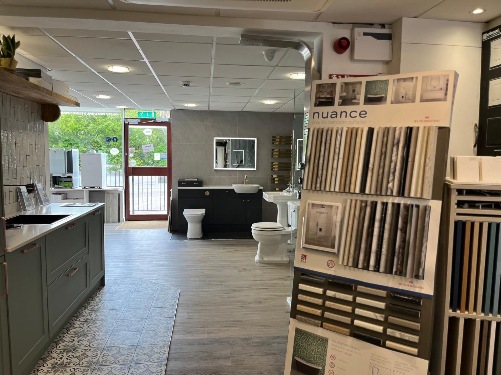 A bathroom showroom with a toilet , sink , and cabinets.