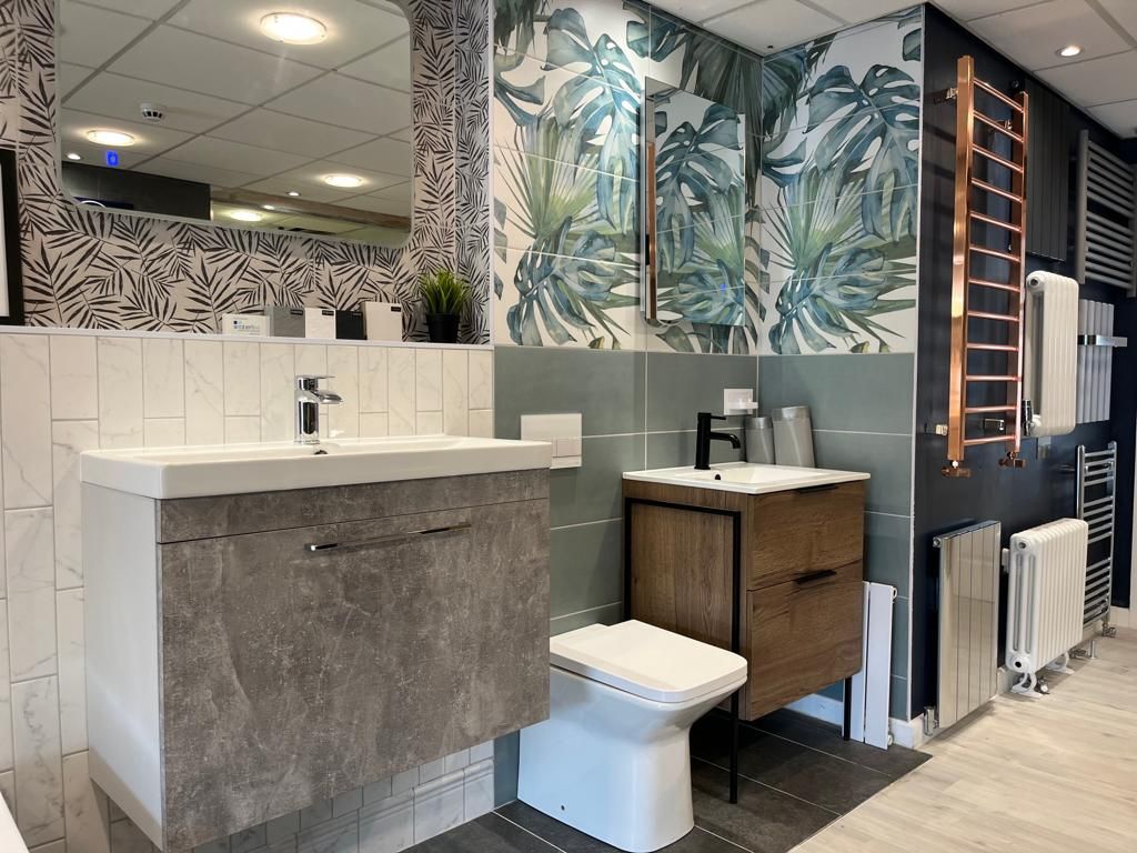 A bathroom with a sink , toilet and mirror.