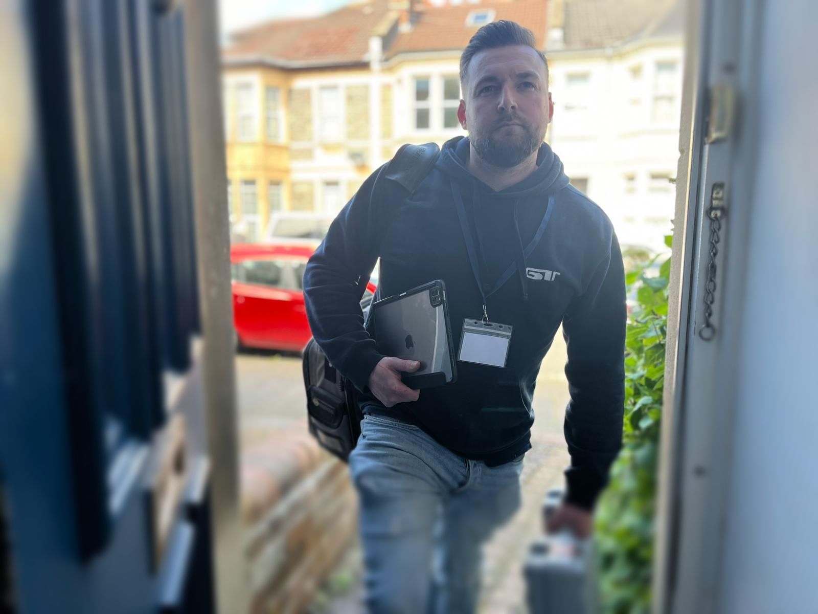 Gary from the GT Team, wearing his ID badge entering a home in St Andrews, Bristol, to service a boiler.