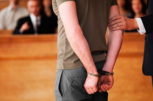 Man in Handcuffs on a Hearing — Danville, KY — McClure, McClure & Bailey
