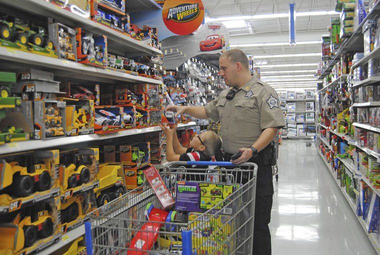 Police Officer Helps a Child Shop — Danville, KY — McClure, McClure & Bailey