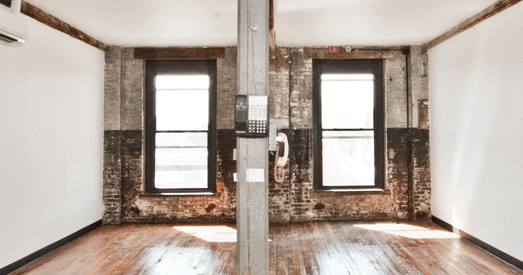 Sunny art studio with 2 windows, brick wall, hardwood floo