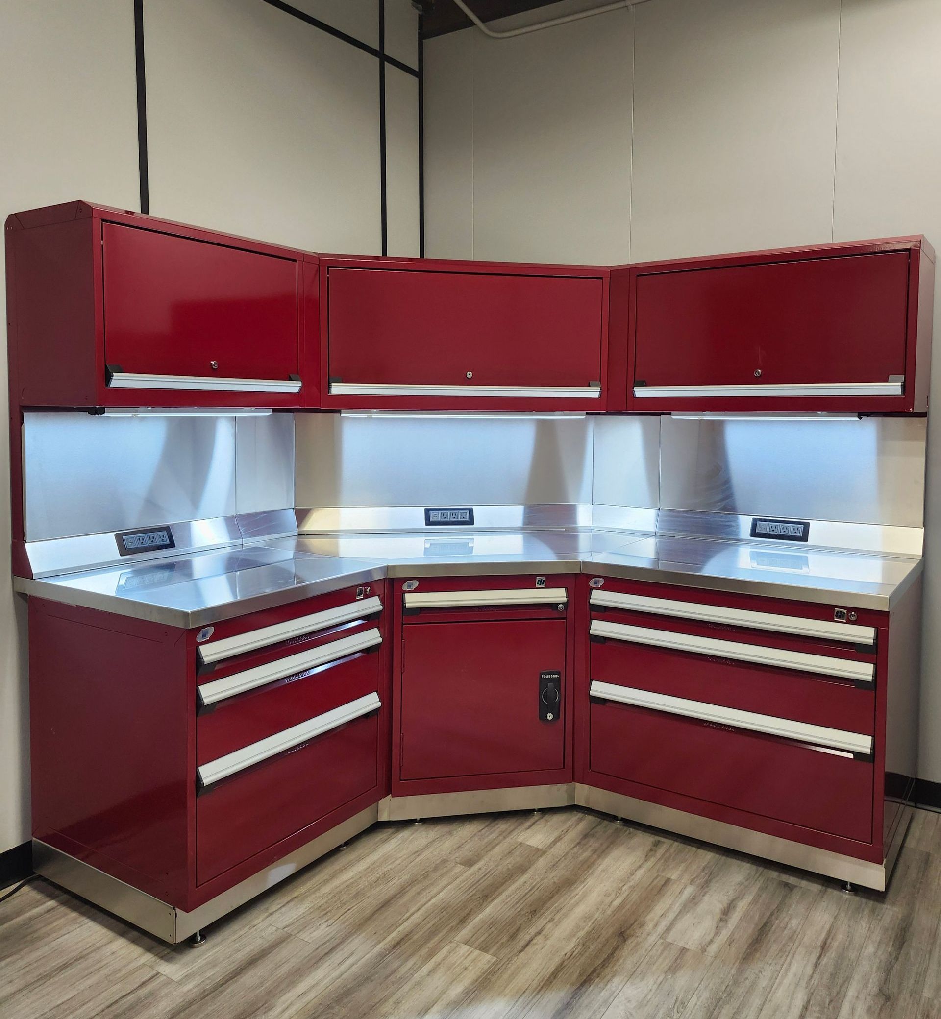 A kitchen with red cabinets and stainless steel counter tops