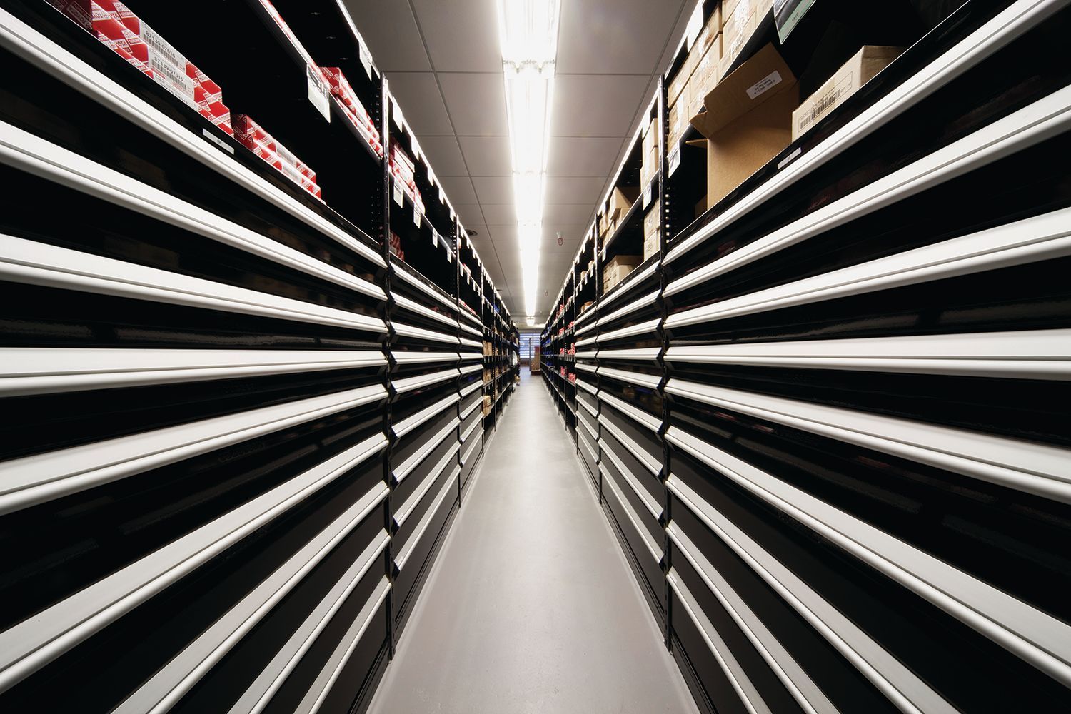 A long hallway with rows of shelves in a store