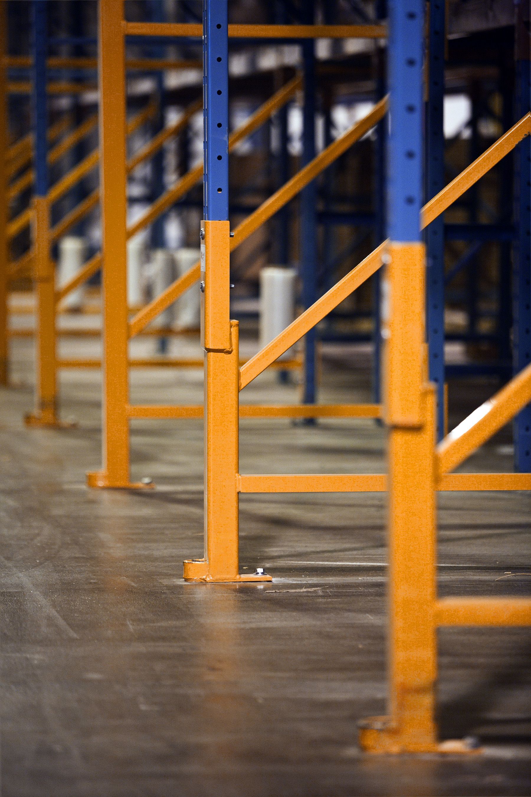 A row of yellow and blue shelves in a warehouse.