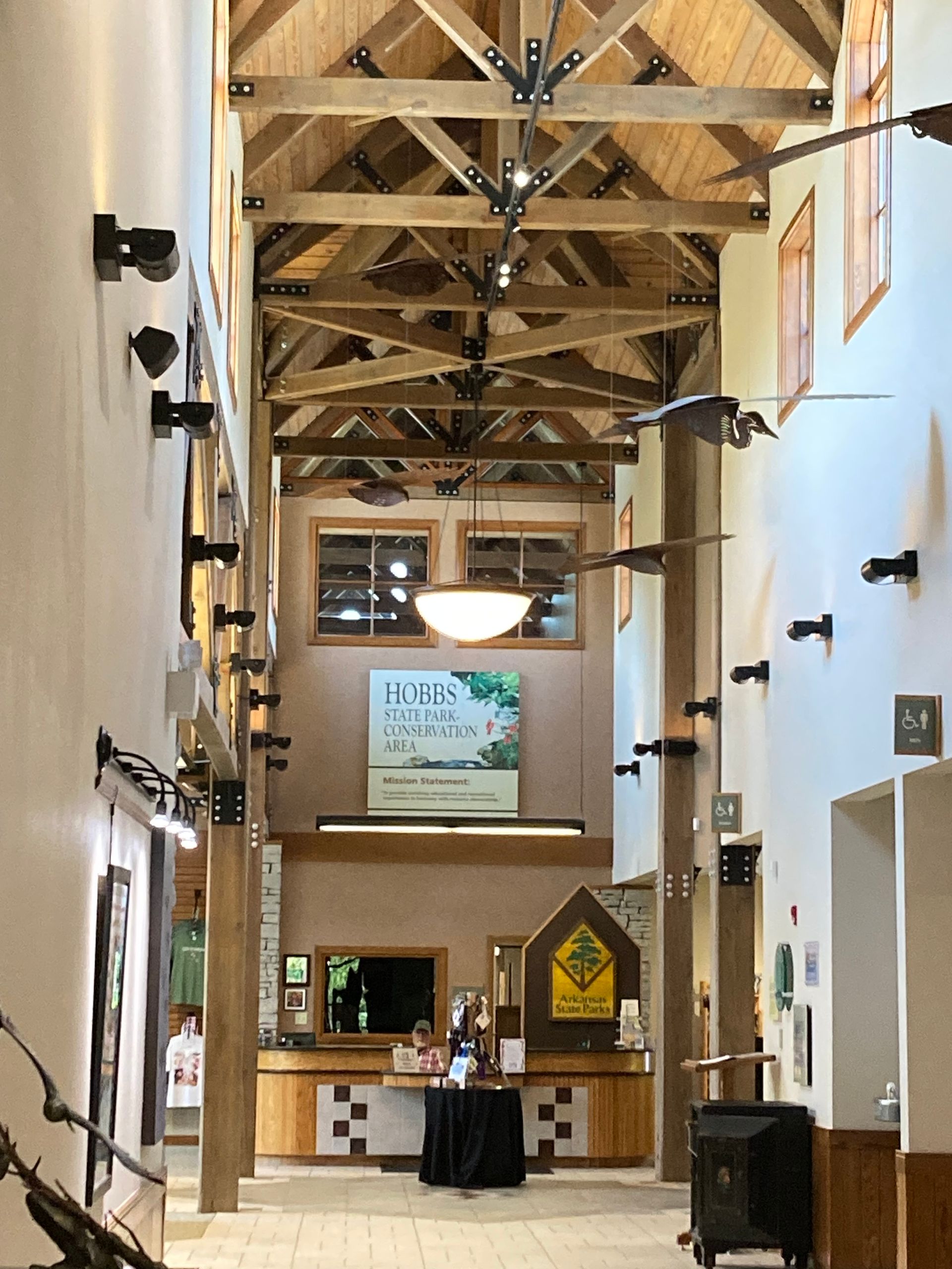 A long hallway with a sign on the wall that says this place