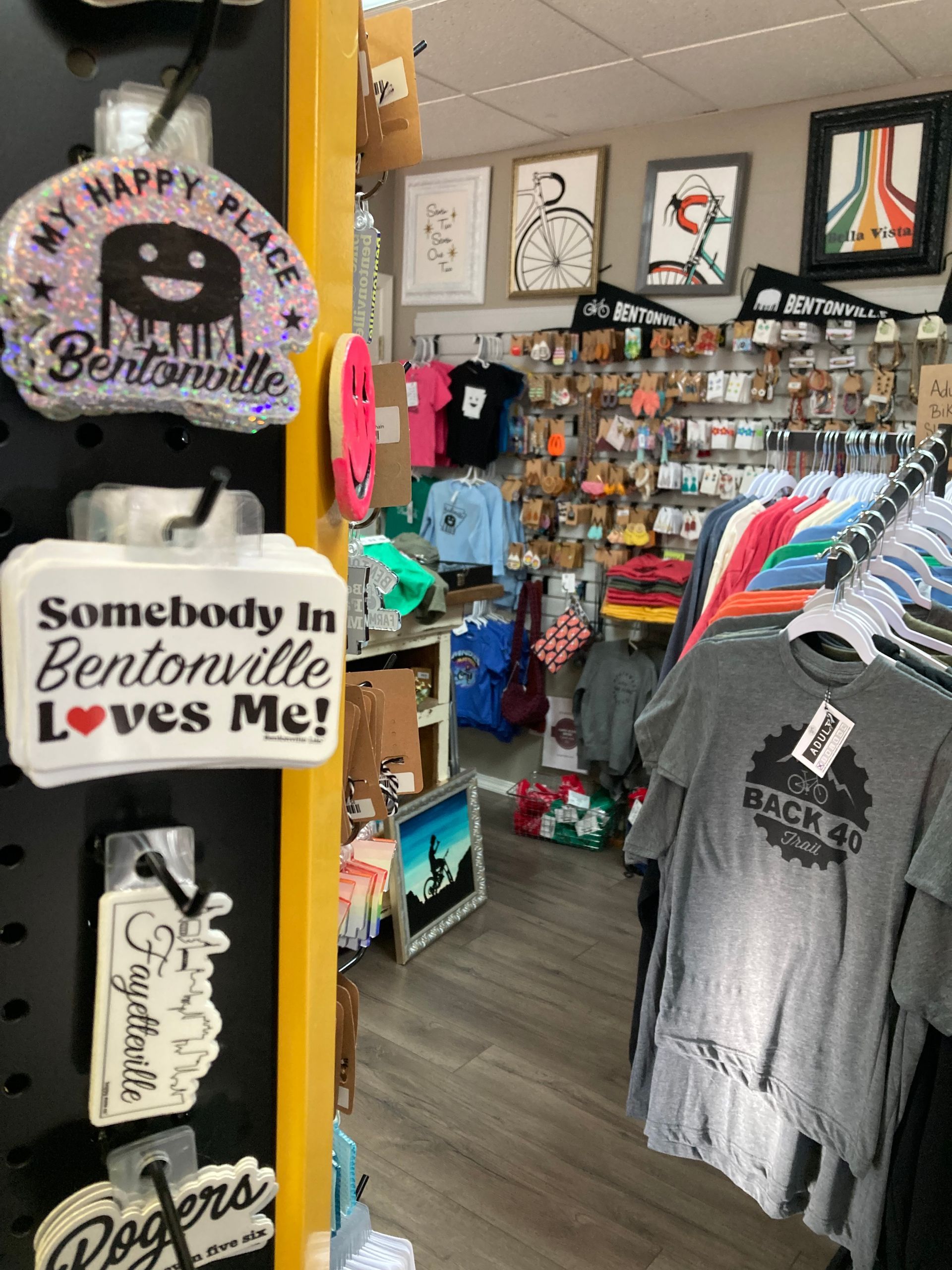 A store filled with lots of clothes and a sign that says `` somebody in bentonville loves me ''.