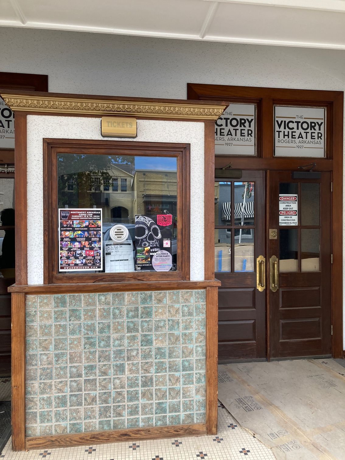 A building with a window and a sign that says victory theater