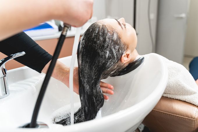 closeup of a hair dresser washing a woman's hair