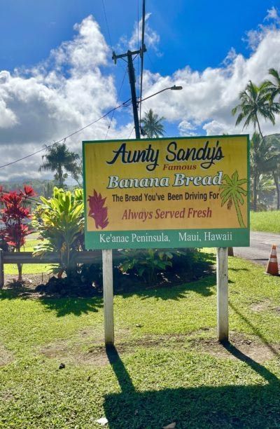 A yellow sign for aunt sandy 's banana bread