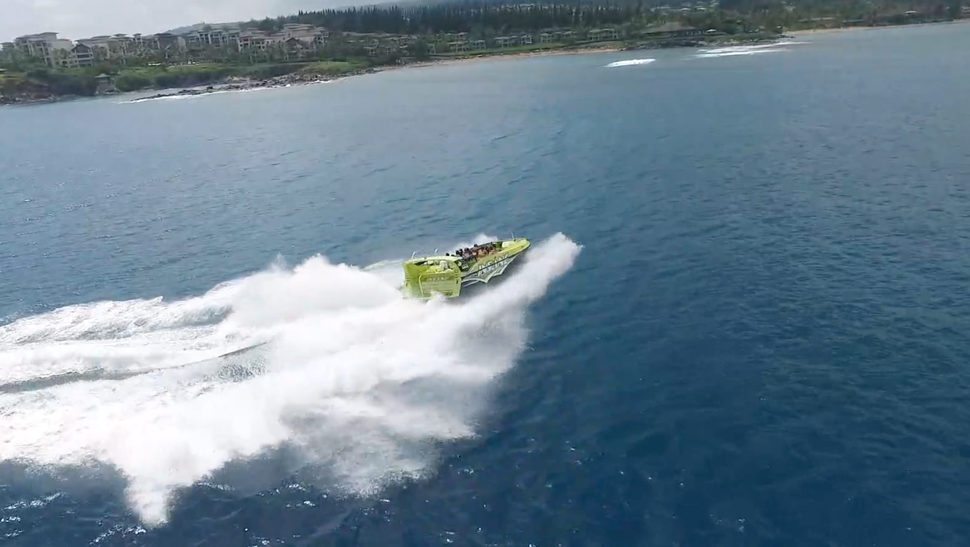 An aerial view of a green jet ski in the ocean.