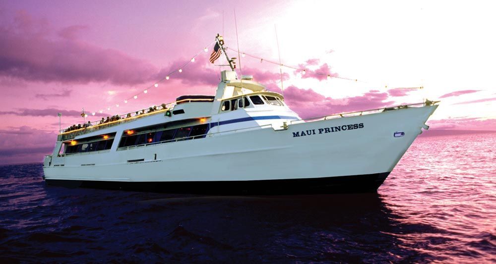 A large white boat is floating in the ocean with a purple sky in the background