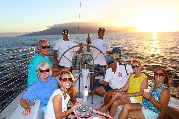 A group of people are sitting on a boat in the ocean.