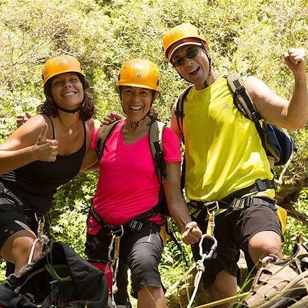 A group of people wearing helmets are posing for a picture.