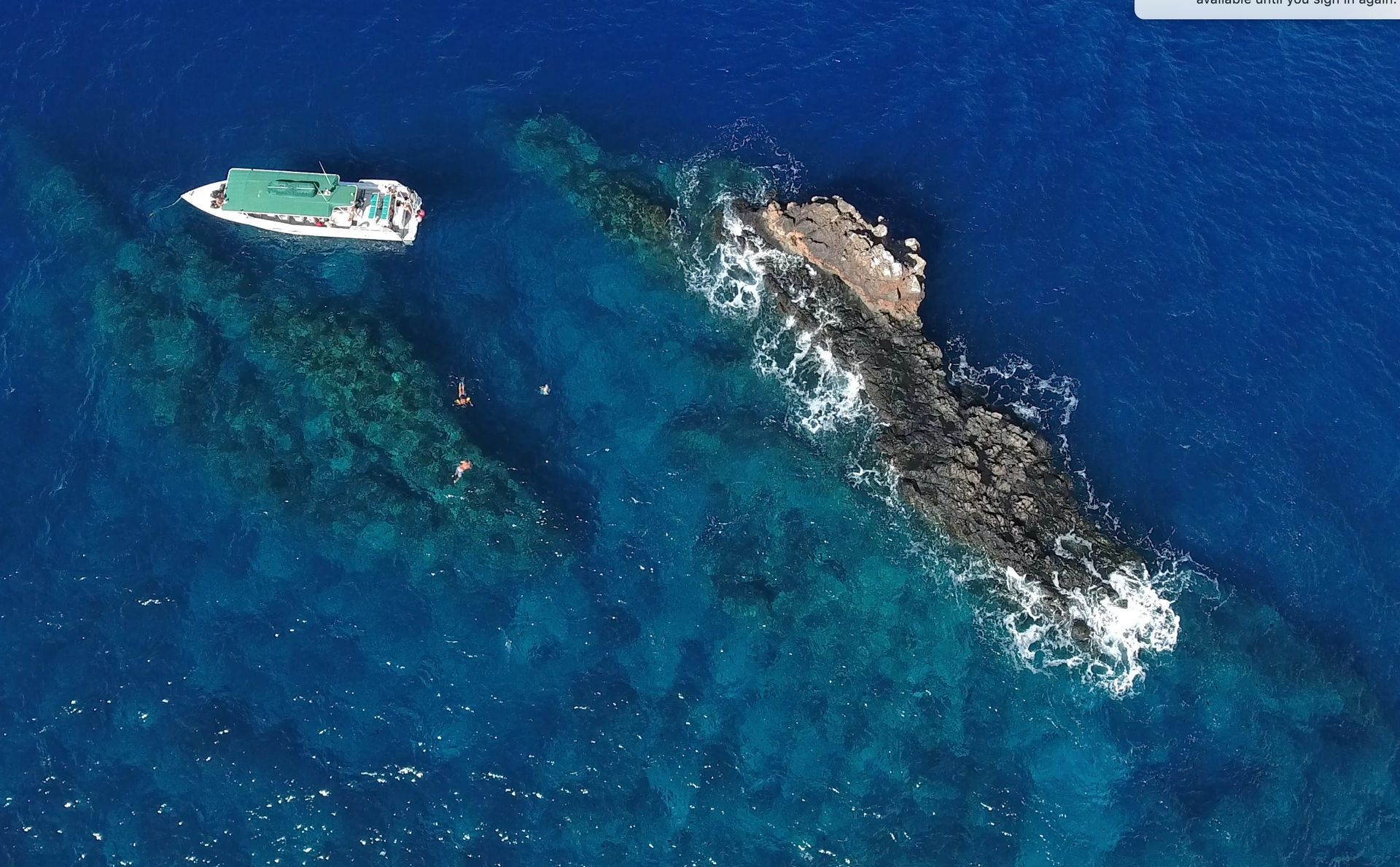An aerial view of a boat in the ocean