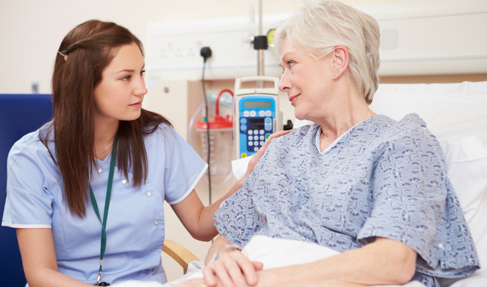 nurse with senior woman in bed