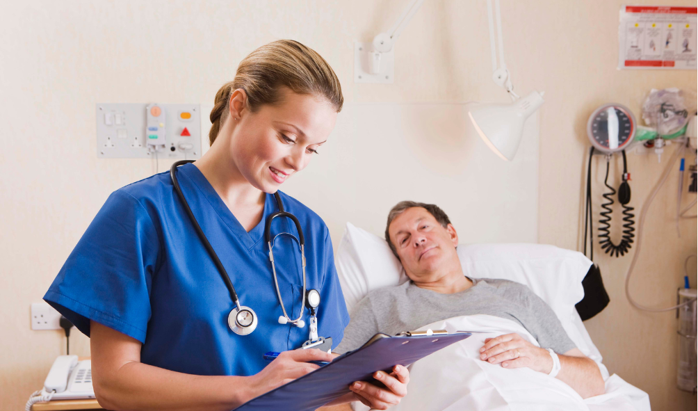 nurse with patient in bed