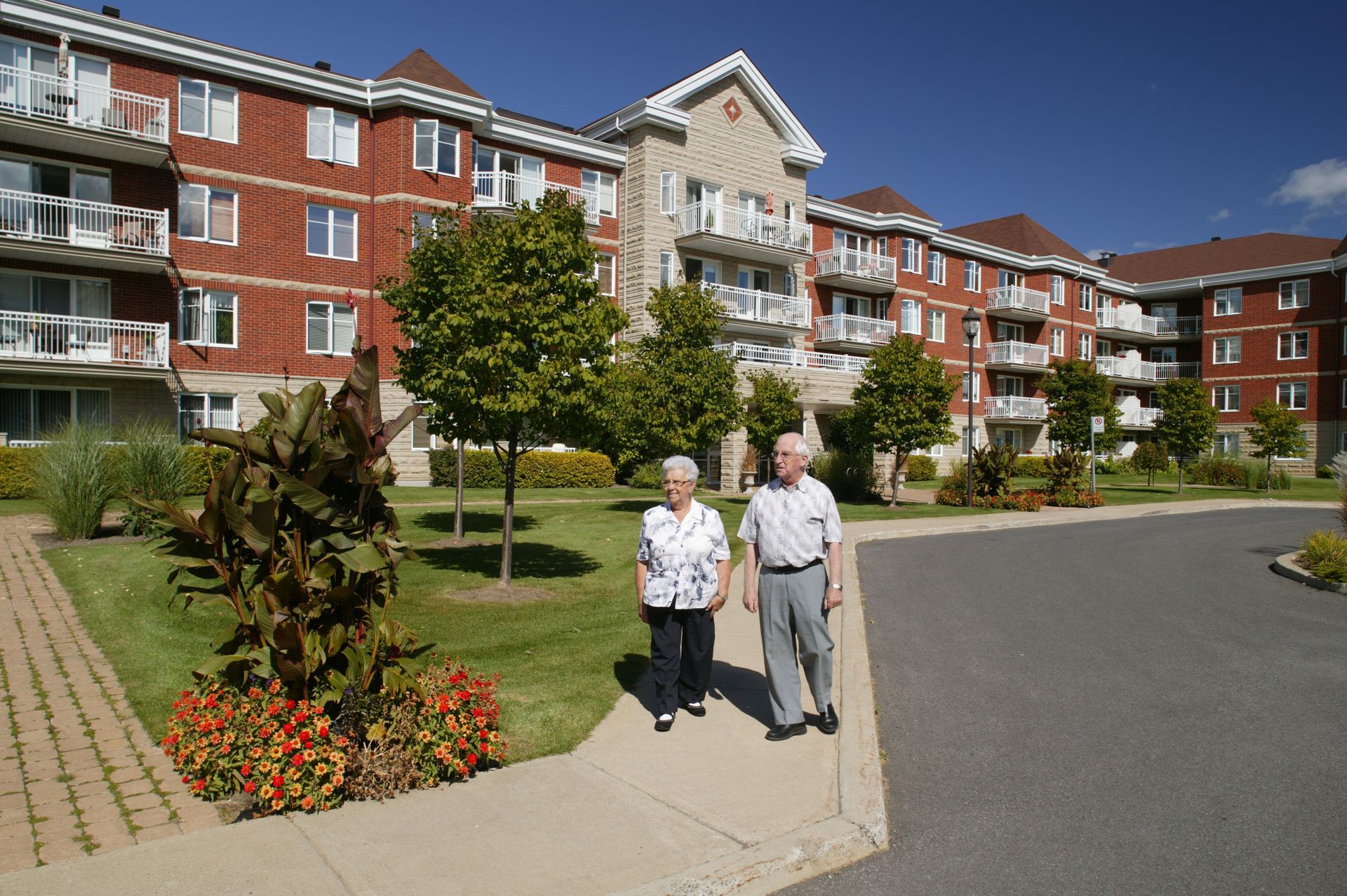 Elderly couple strolling outside.