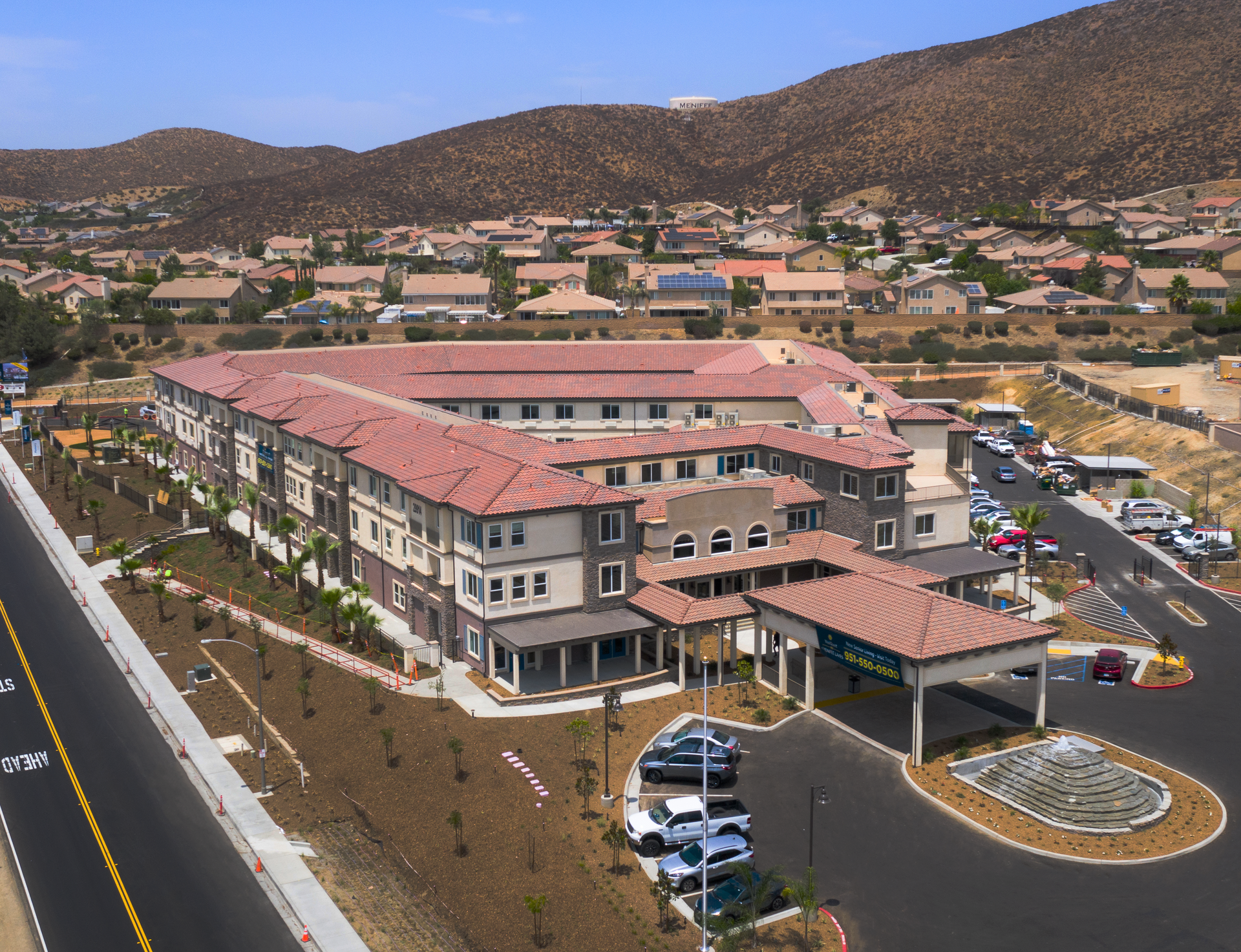 Senior couple walking outdoors, in front of a senior living building facility. Senior couple walking outdoors, in front of a senior living building facility.