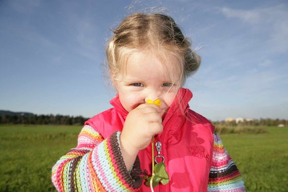 little girl in a pink vest